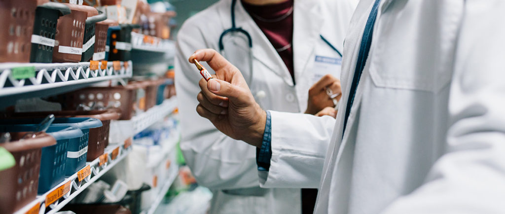 A doctor holding a vial