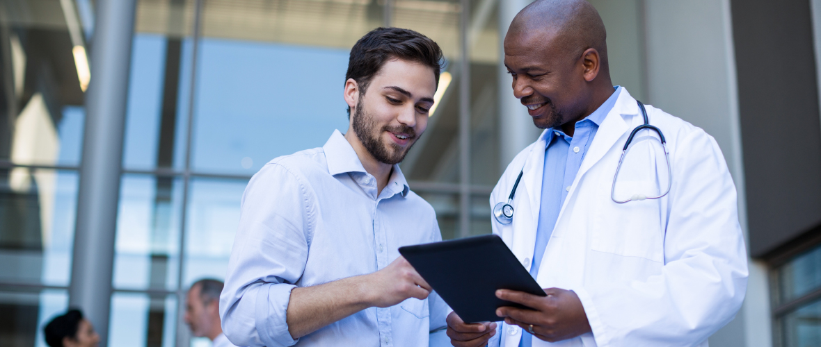 Doctor with tablet talking to patient