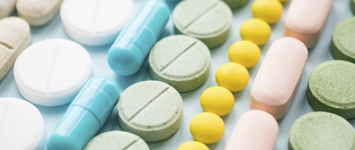 a variety of pills lined up on a table