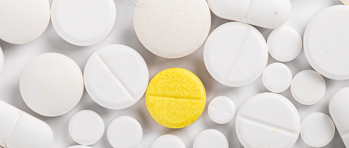 white and yellow pills on a table