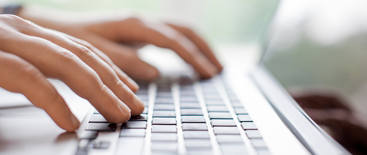 a person typing on a laptop