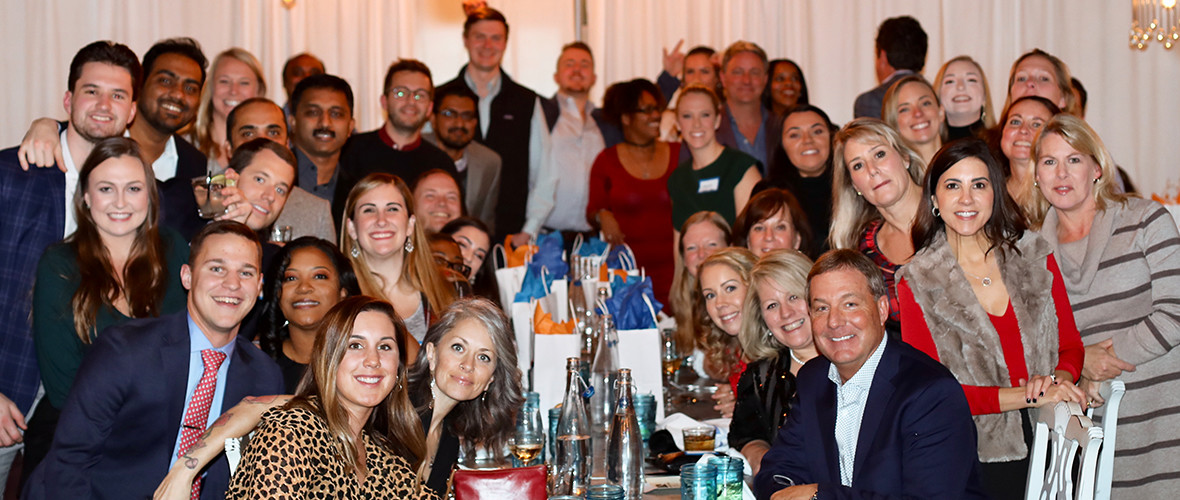 Members of the RXNT team pose together at a holiday party