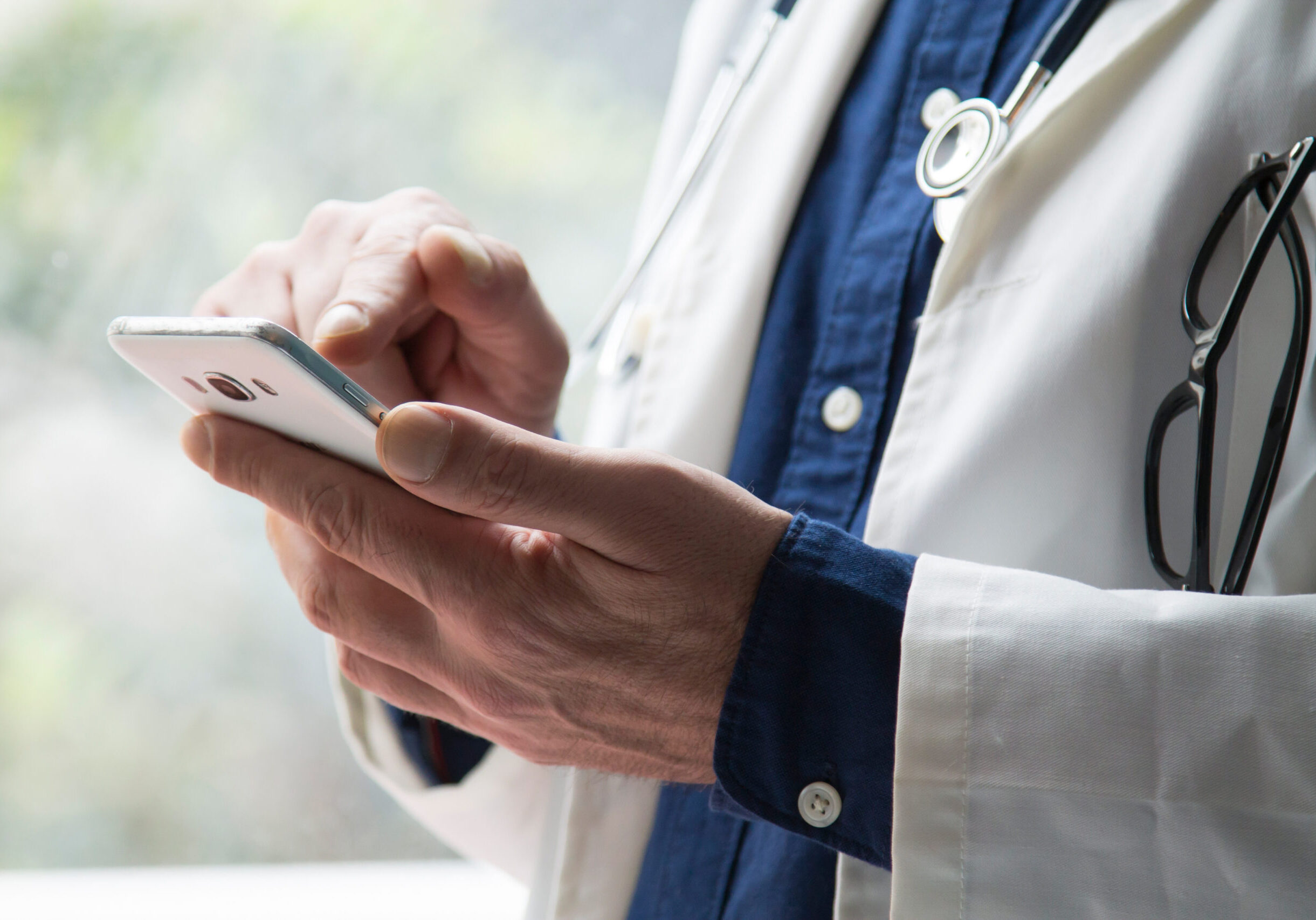 doctor using mobile phone close up view