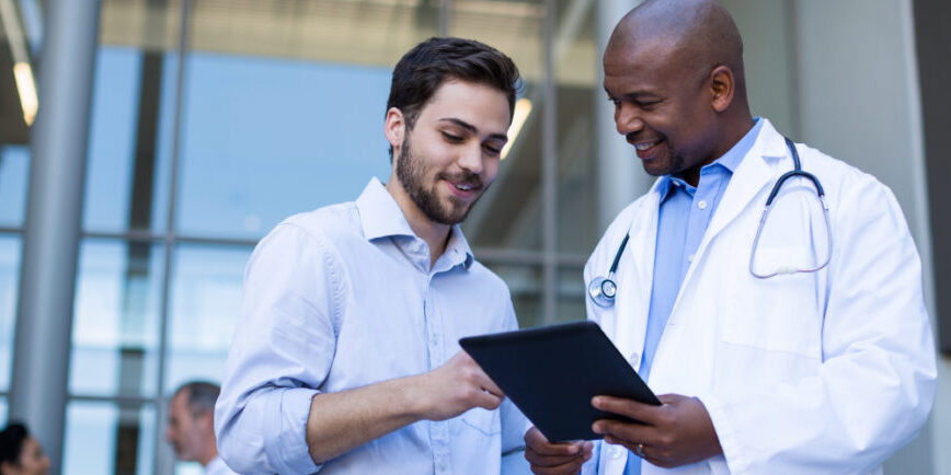 Doctor with tablet talking to patient