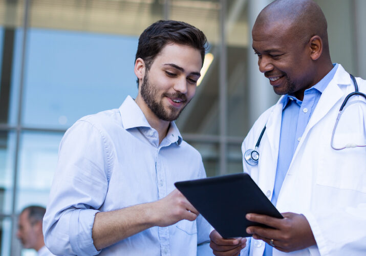 Doctor with tablet talking to patient