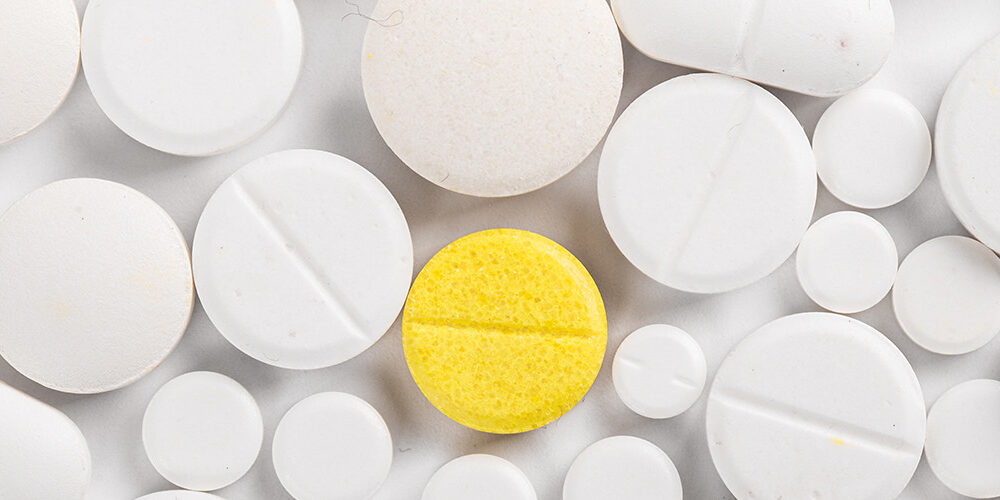 white and yellow pills on a table