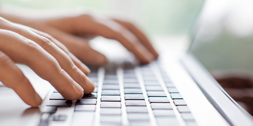 a person typing on a laptop