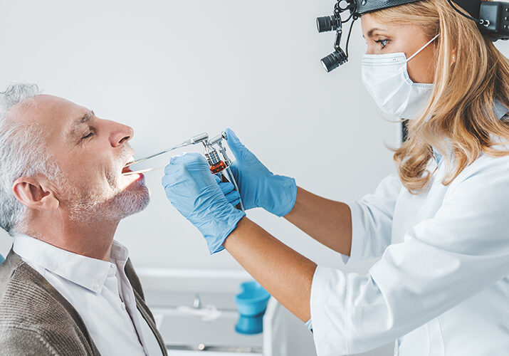 ENT doctor checking patient's throat