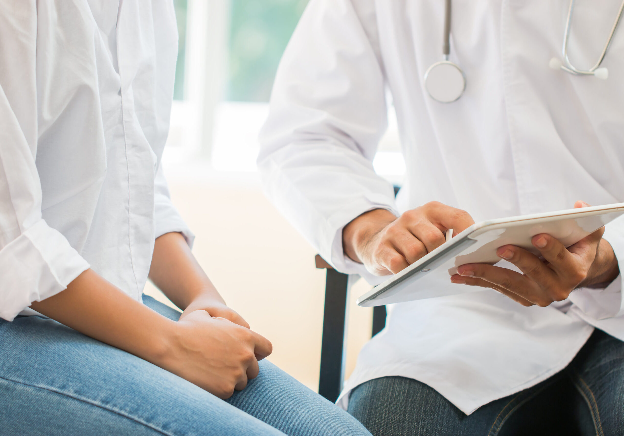 Doctor using tablet to show patient information